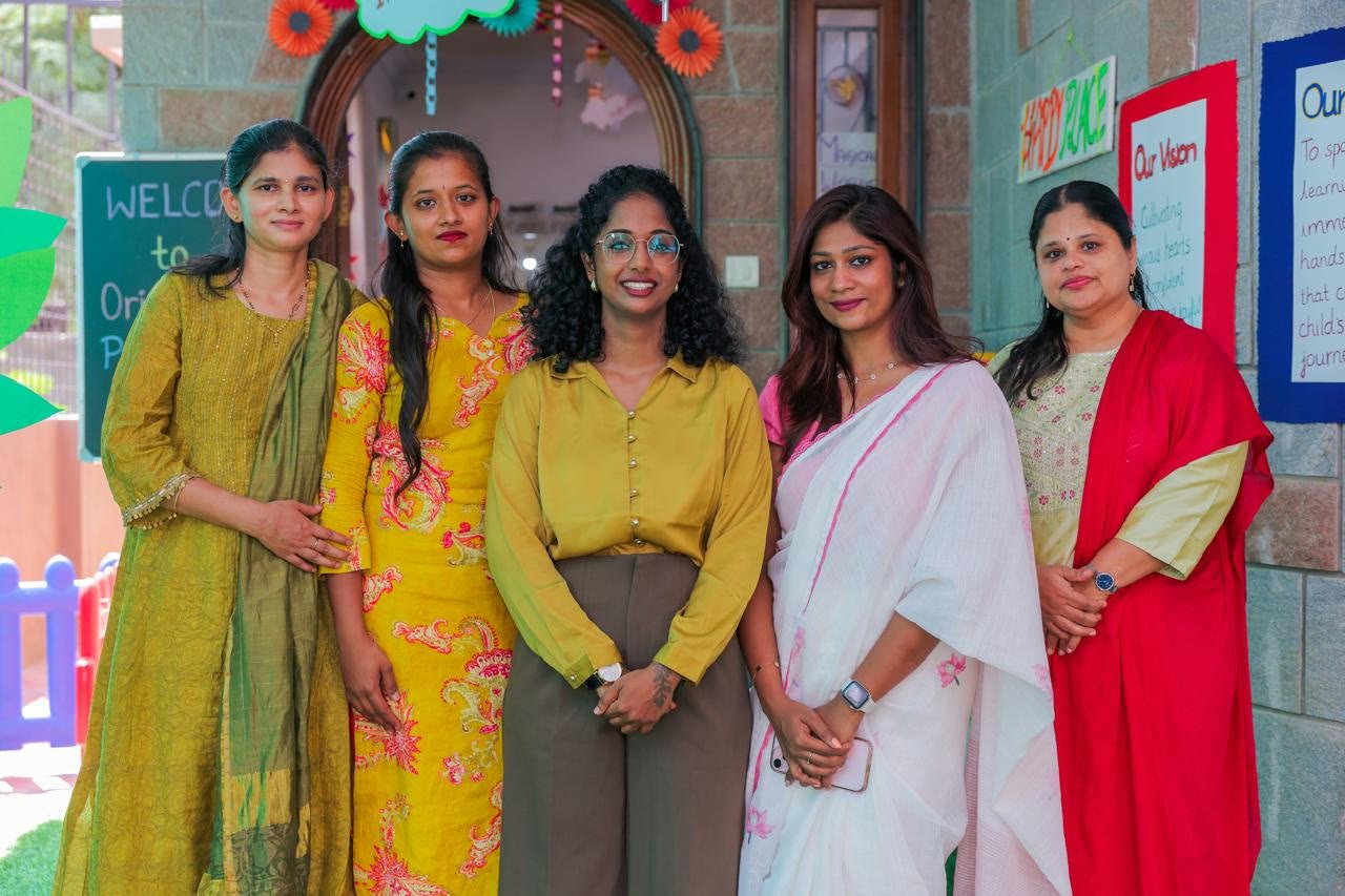 Little Odyssey Whitefield teaching staff standing together outside the play school entrance